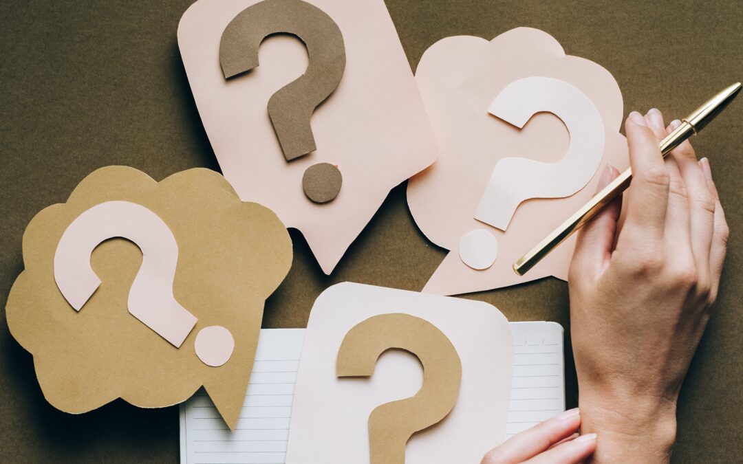 question marks and a blank notebook - questions to ask accountant